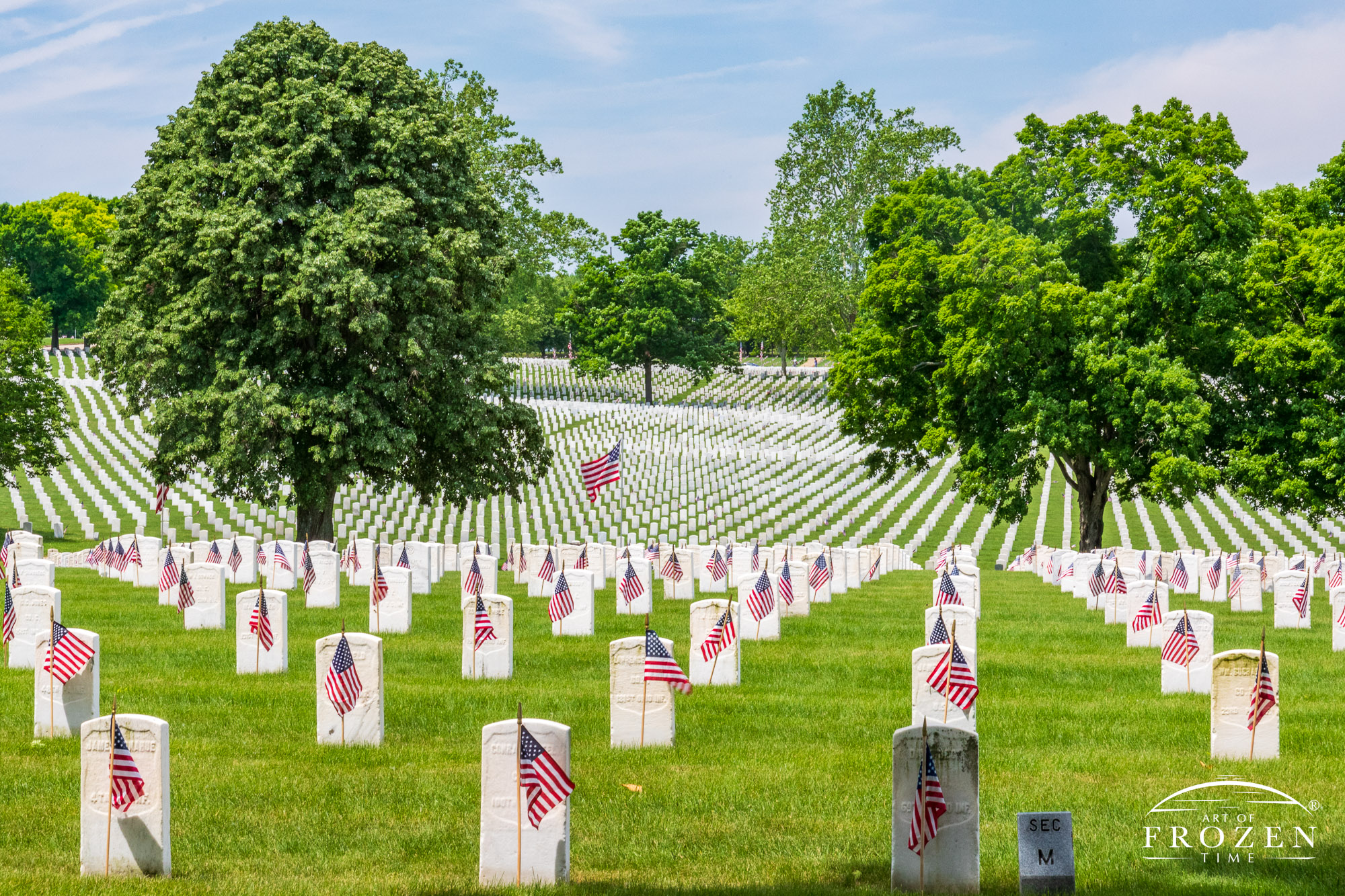 Acres of perfectly aligned white headstones each with a small US Flag placed by local scouts for Memorial Day at Dayton National Cemetery