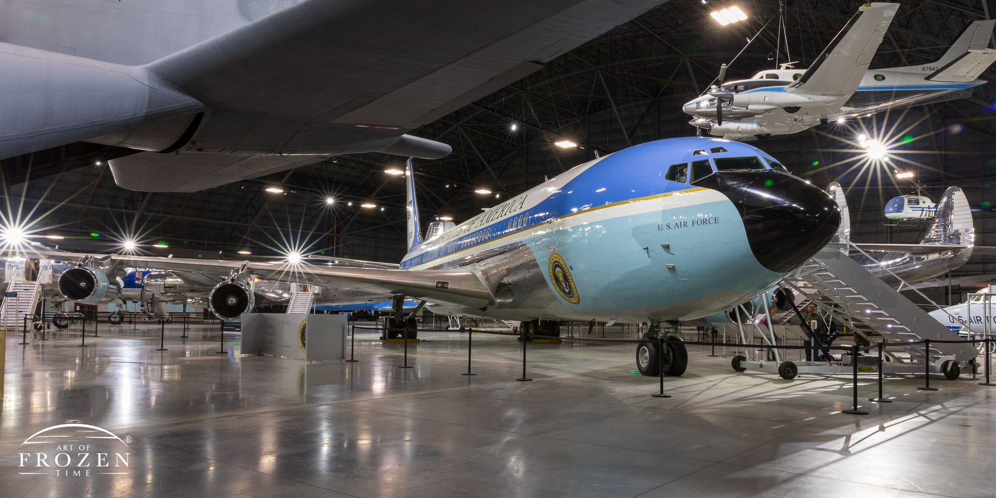 A front and side panorama of the former Air Force One aircraft known as SAM 26000 displaying its robin egg blue color as it sits in the National Museum of the US Air Force.