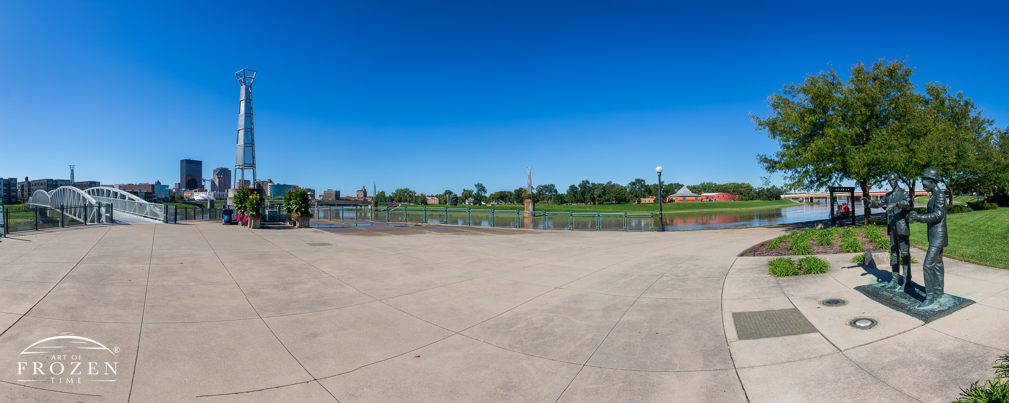 A panorama of Legacy Plaza featuring the life-size sculpture of the Wright Brothers under the bluest skies of the year