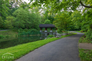 A peaceful morning view of the Dogwood Pavilion at Hills and Dales MetroPark where a walking path meanders along Dogwood Pond