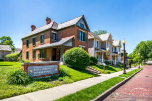 Paul Laurence Dunbar House Historic Site on a clear blue Spring Day with red brick street.