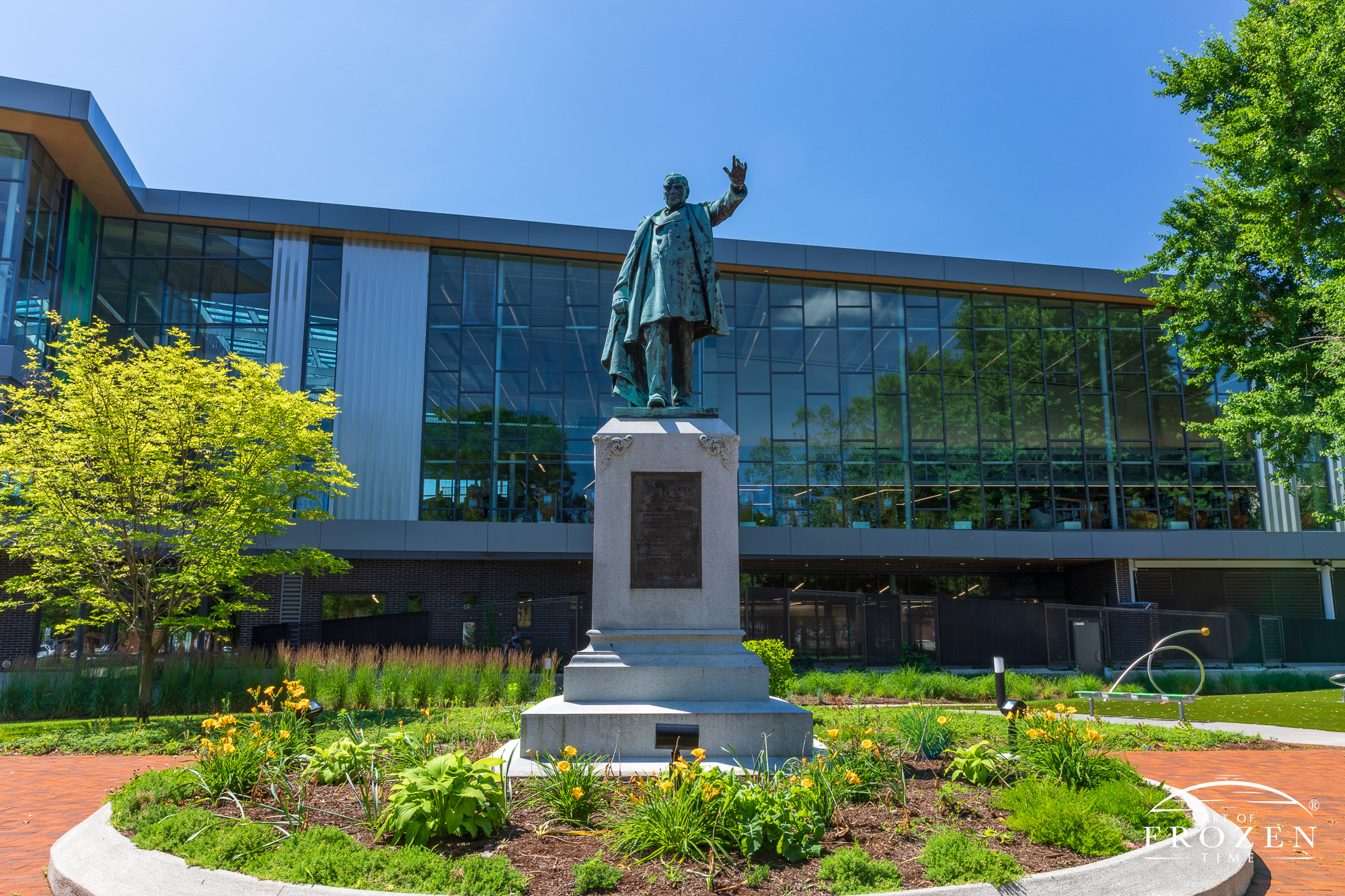 A bronze statue paying tribute to Ohio resident, President William McKinley shows 100 years of patina as it resides in front of the new Dayton Library in Cooper Park
