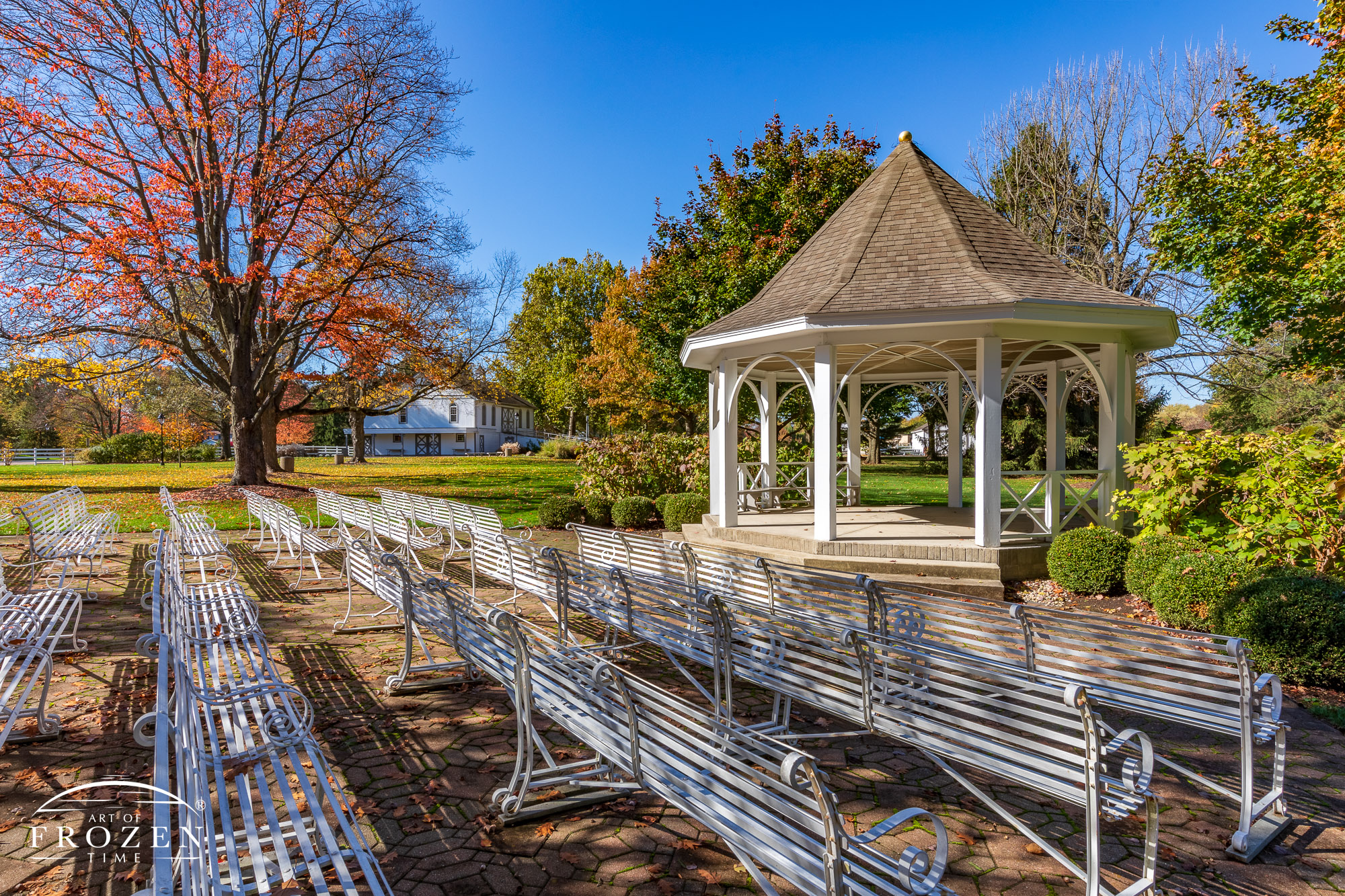 The gazebo at Polen Farms, Kettering Ohio, under autumn colors and fall lighting where the benches are ortiented for guest to witness special occasions.