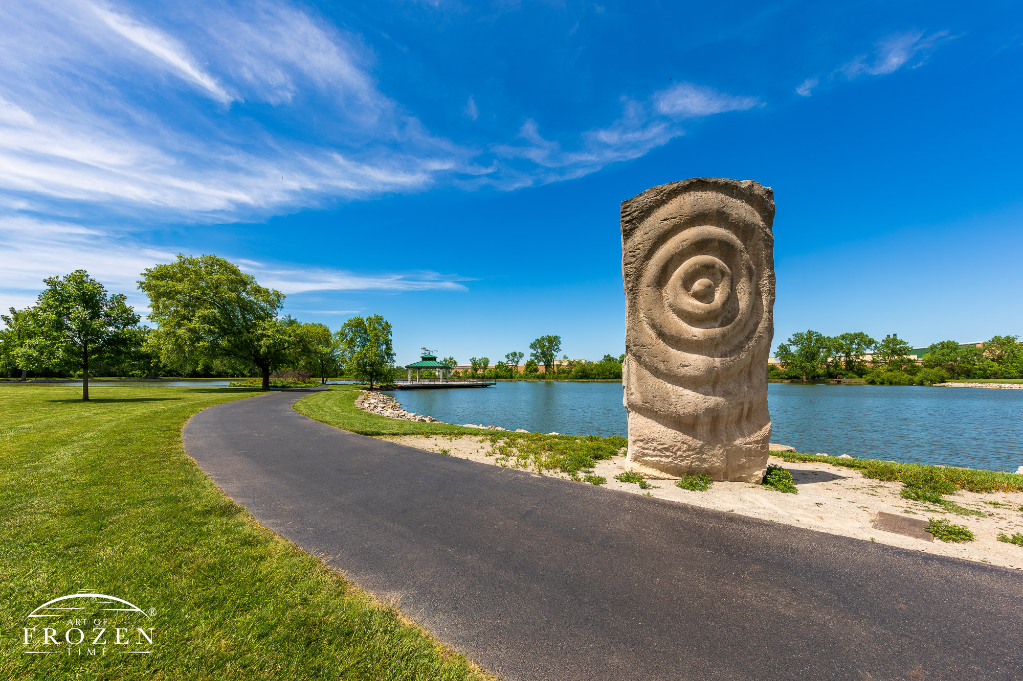 A stone sculpture depicting water ripples placed near the lake side walking path in Delco Park, Kettering Ohio.