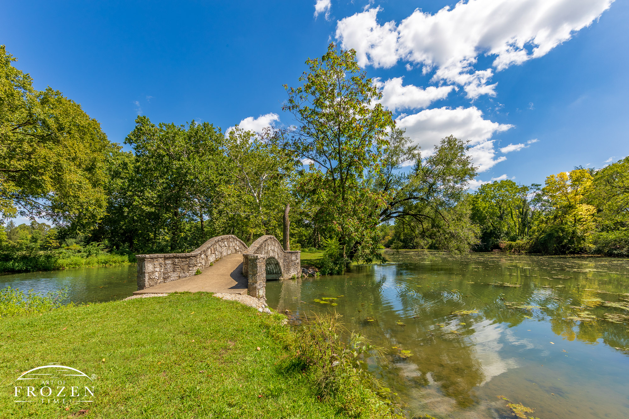 A perfect day at Eastwood Lake MetroParks as stone bridges invite visitors to explore the park’s paths through mature trees under amazing skies