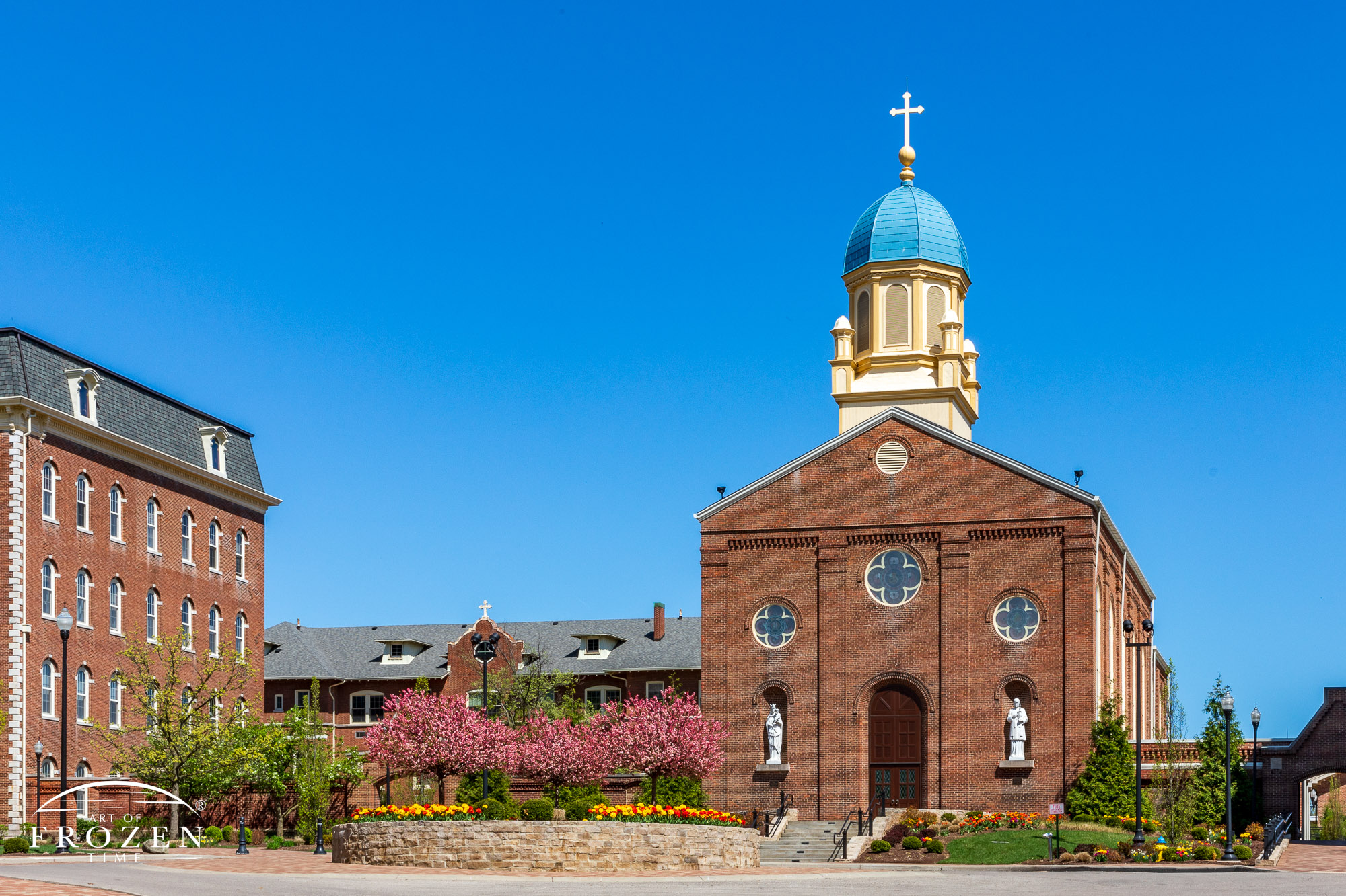 The University of Dayton's Chapel of the Immaculate Conception on a blooming spring day under blue skies