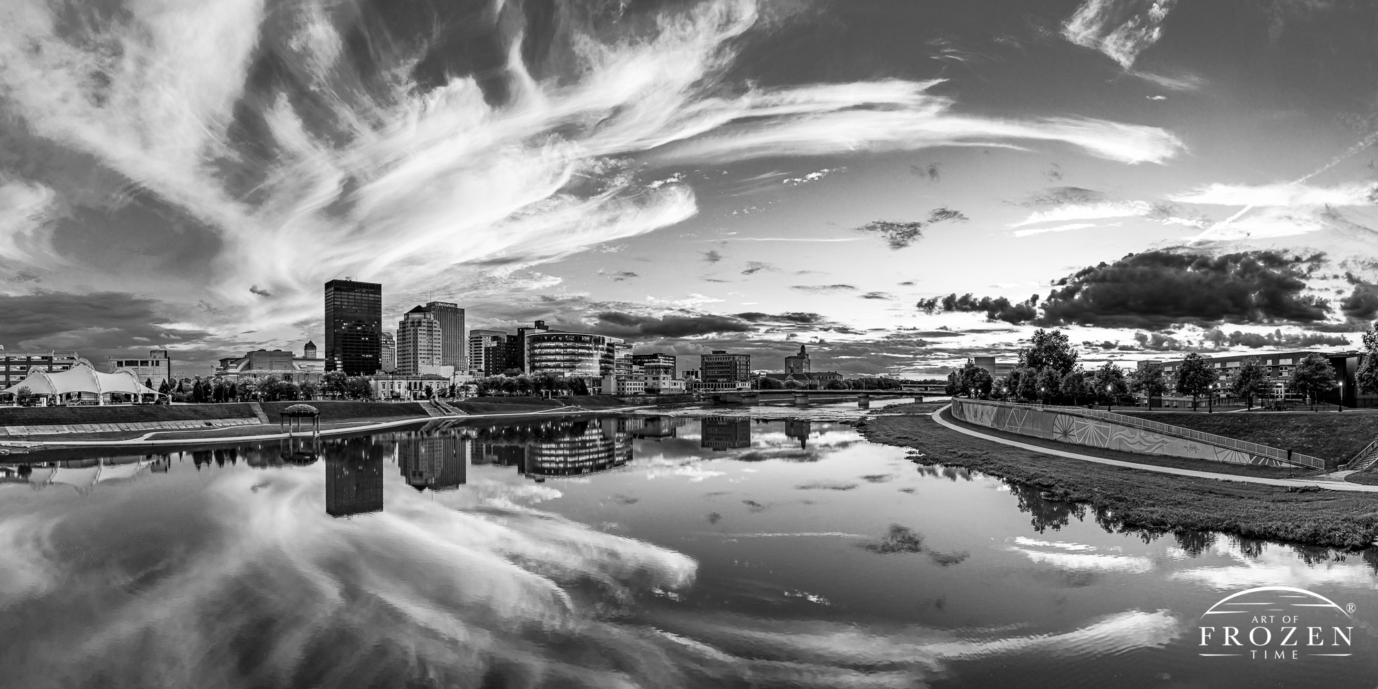 Black and white print of the Dayton Ohio Skyline where cirrus clouds remain illuminated as the sun sets over the Miami Valley