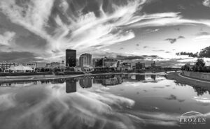 Black and white print of the Dayton Ohio Skyline where cirrus clouds remain illuminated as the sun sets over the Miami Valley