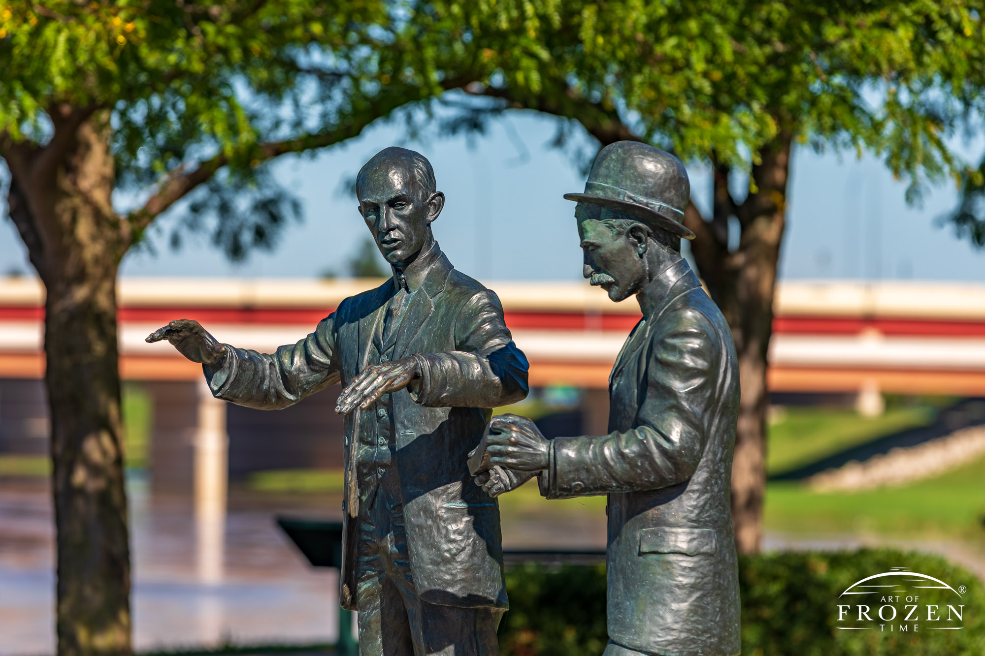 Life-size sculpture of the Wright Brothers depicts them in conversation in front of the Dayton Fountains