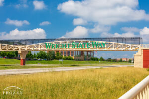 A pedestrian bridge spans I-675 with lettering of “Wright State Way” which connects WSU with restaurants and healthcare destinations