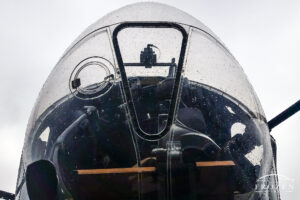 A cropped image of a B-17G rendered in black and white focusing on the bubble canopy around the bombardier position