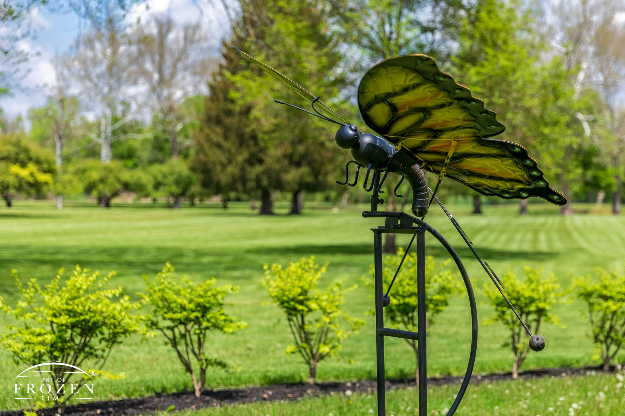 Near the Kiwanis Children’s Garden waterfall feature lies this wind mobile of a bronze butterfly with moves its wings in a slight breeze.