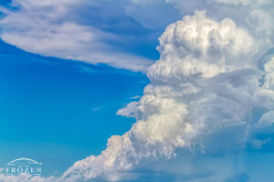 A close up of a cumulous nimbus hanging in the Colorado skies which reveals the angry water vapor moving in many directions as its core lifts the moisture to the upper parts of the atmosphere creating a classic anvil top