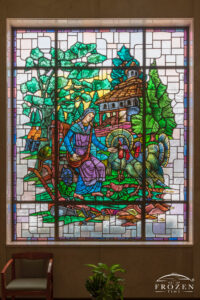 Historic stained-glass windows created by Louis Comfort Tiffany featuring his opalescent glass depicting a lady feeding a group of turkeys