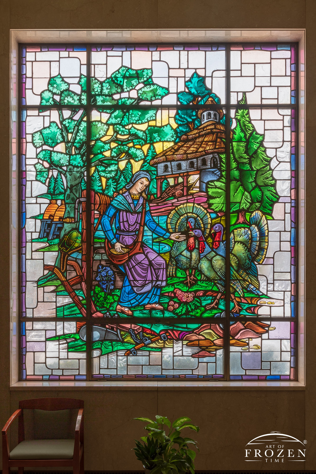 Historic stained-glass windows created by Louis Comfort Tiffany featuring his opalescent glass depicting a lady feeding a group of turkeys