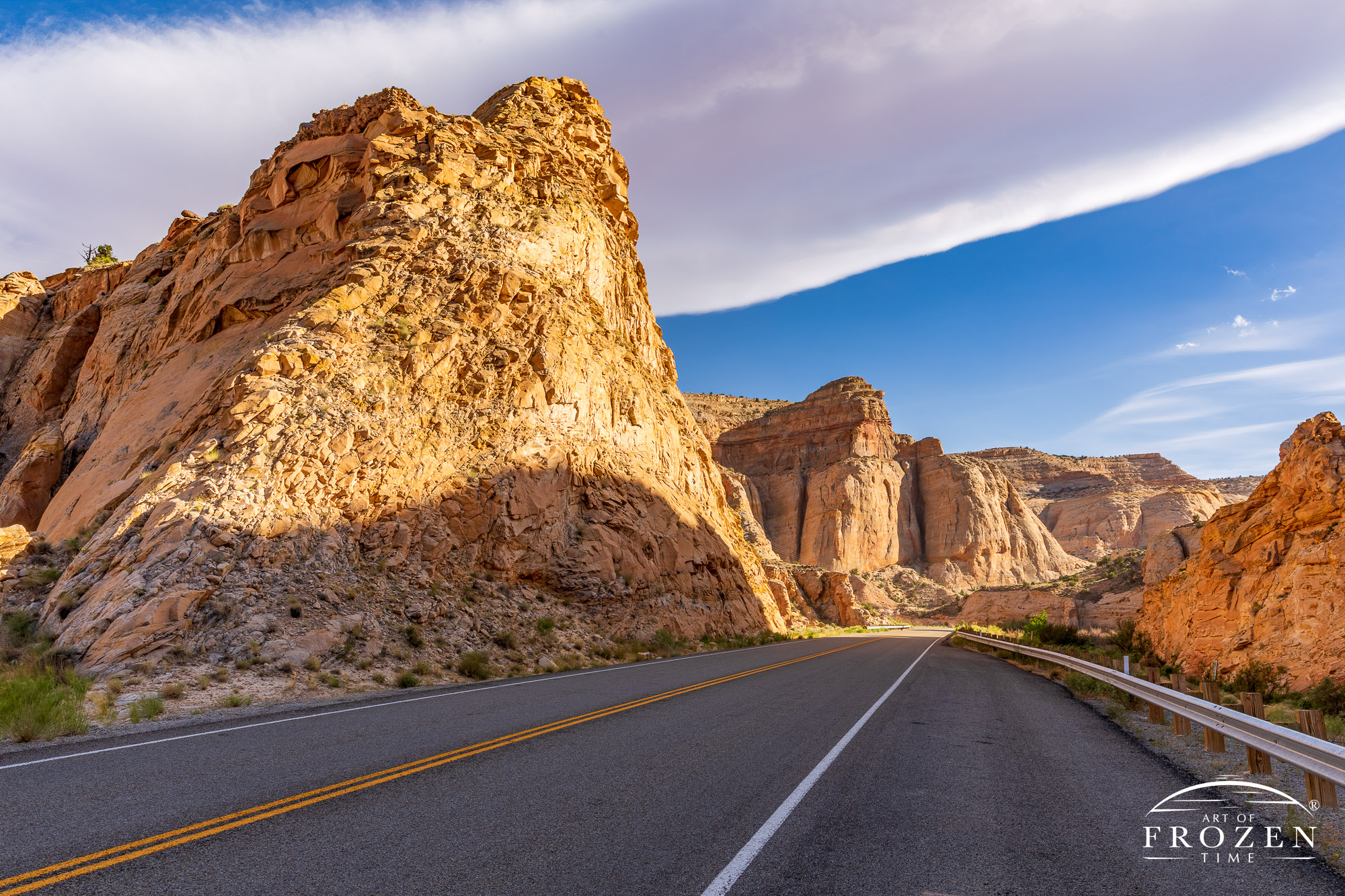 A road cut through white Navajo Sandstone layers was Utah Scenic Byway 24 winds through Capitol Reef National Park