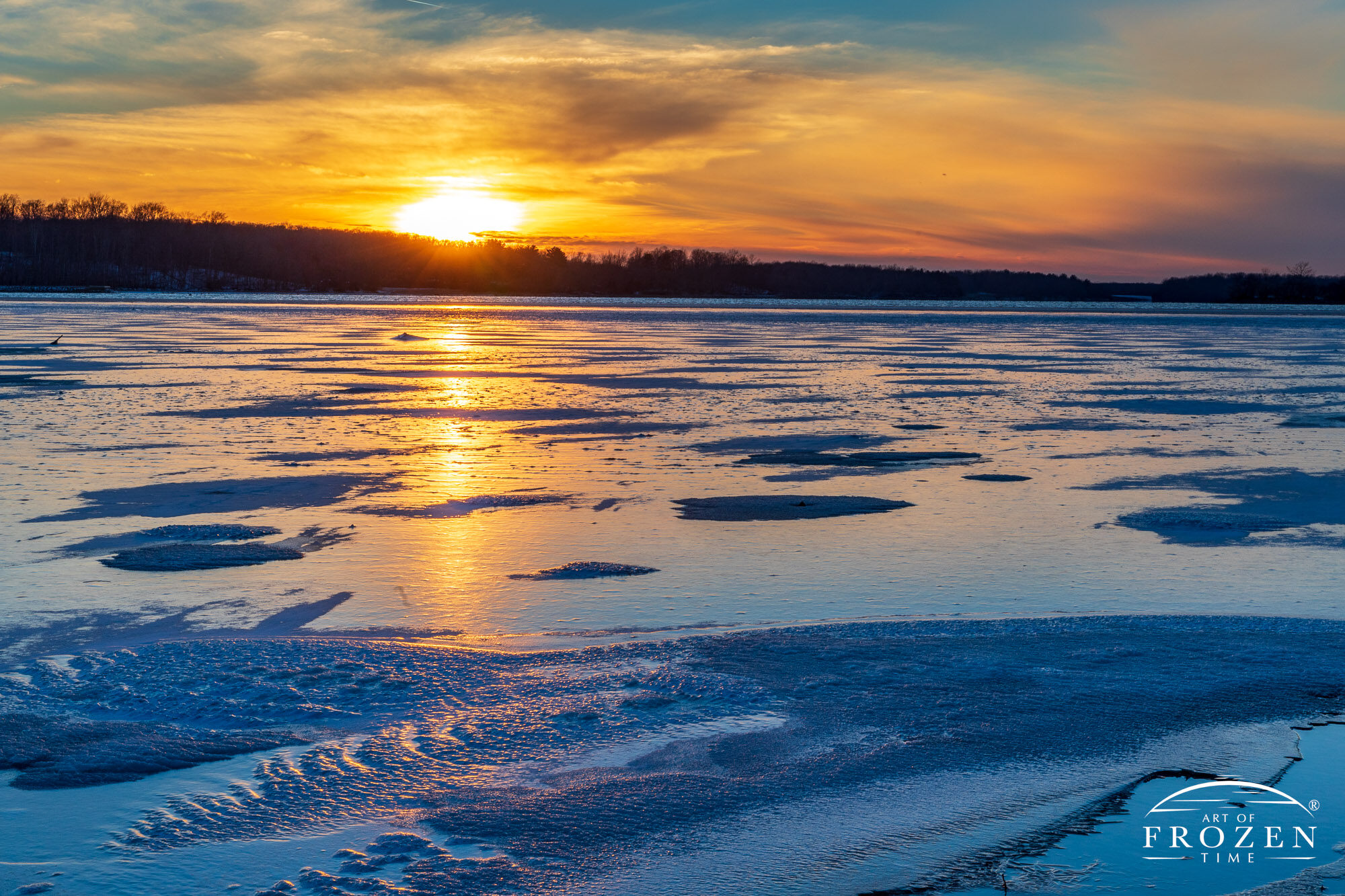 Interesting textures and ripples locked in place as the dusky sunset sets over this frozen lake.
