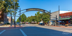 A steel sign arching over North Third Street in Hamilton Ohio designating the German Village Historic District entrance