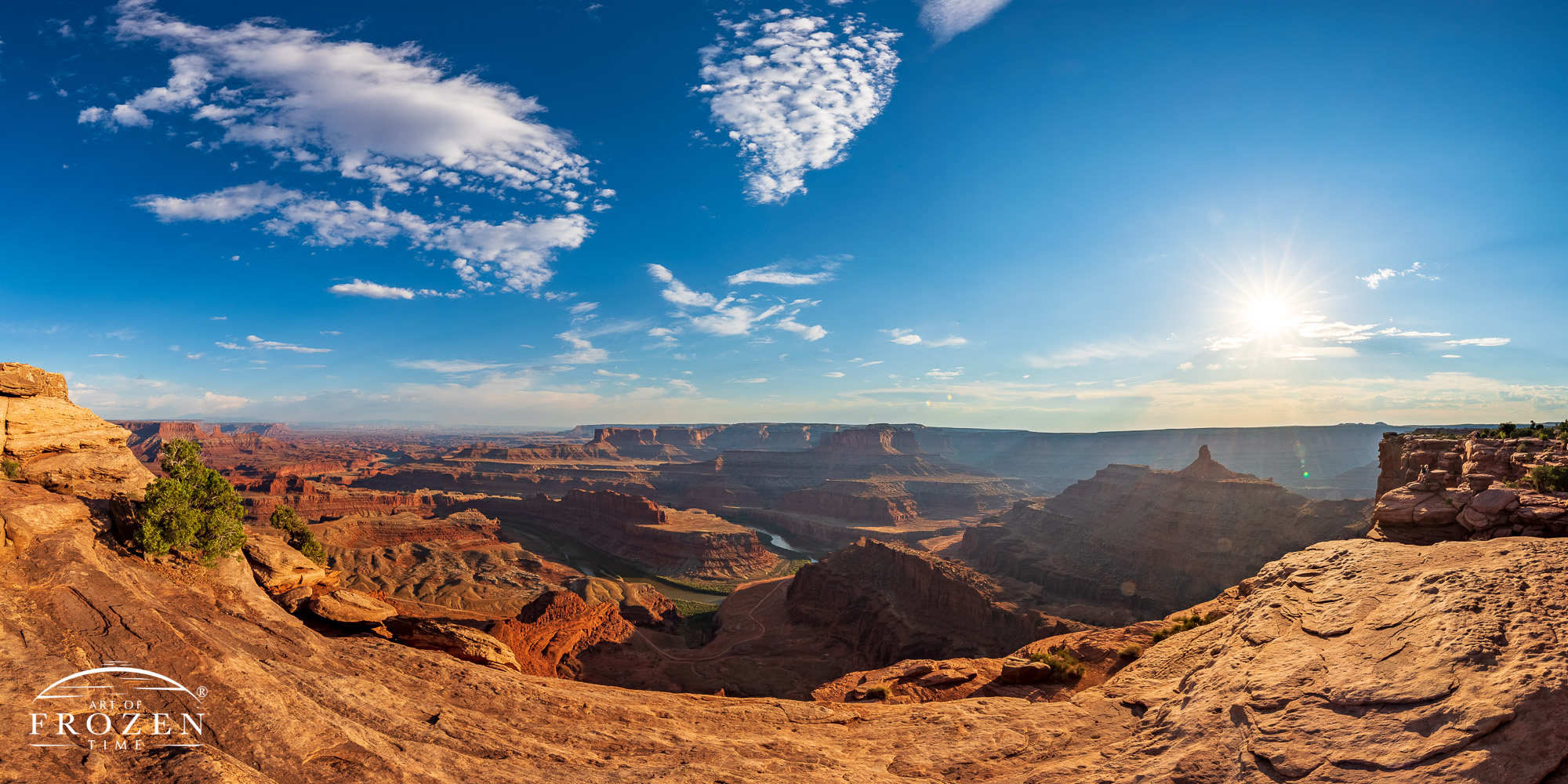An evening view from Dead Horse Point, near Moab Utah were the golden evening light rakes across the Jurassic sedimentary layers revealed by the Colorado River