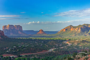 A morning view of Arizona State Route 179 leading the eye towards Sedona’s Bell Rock formation where golden light washes over the red rocks of the Schnebly Hill Formation