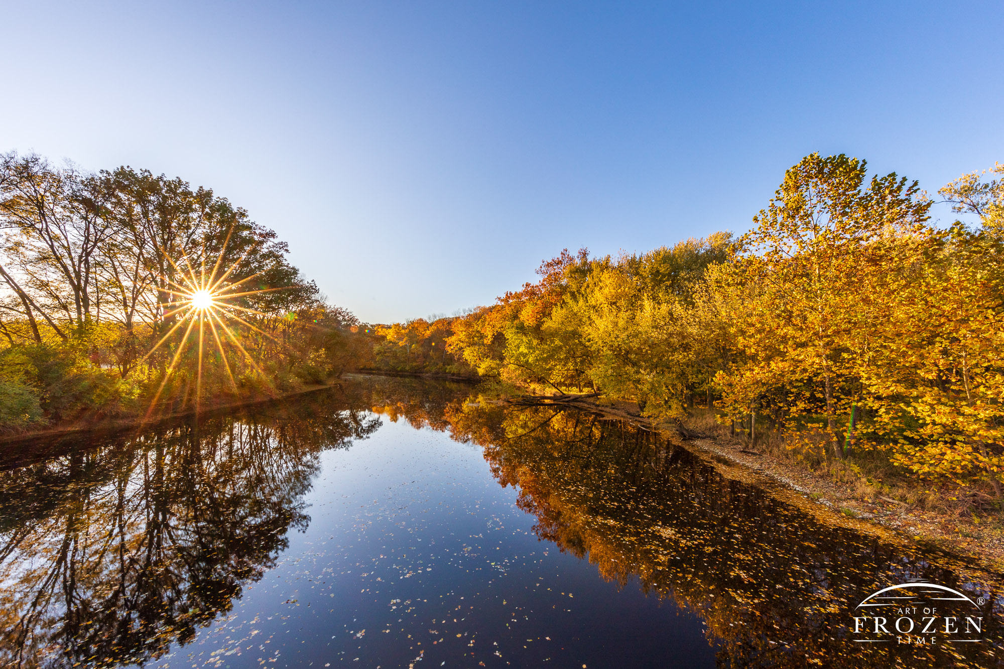 A classic Ohio scene where the Great Miami River takes on a glassy surface and brightly reflects the sun’s last rays