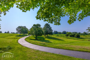 Under the hazy July skies, the walking path leads residents among the park’s trees