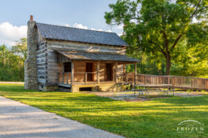 A rear view of the Indian Mound Reserve Log Home in Cedarville, Ohio, where the warm evening light washes over the back porch