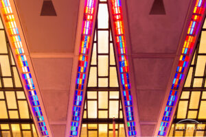 As sunrise occurs over the Air Force Academy Cadet Chapel, its pink and lavender stain glass windows fill the interior with unique hues