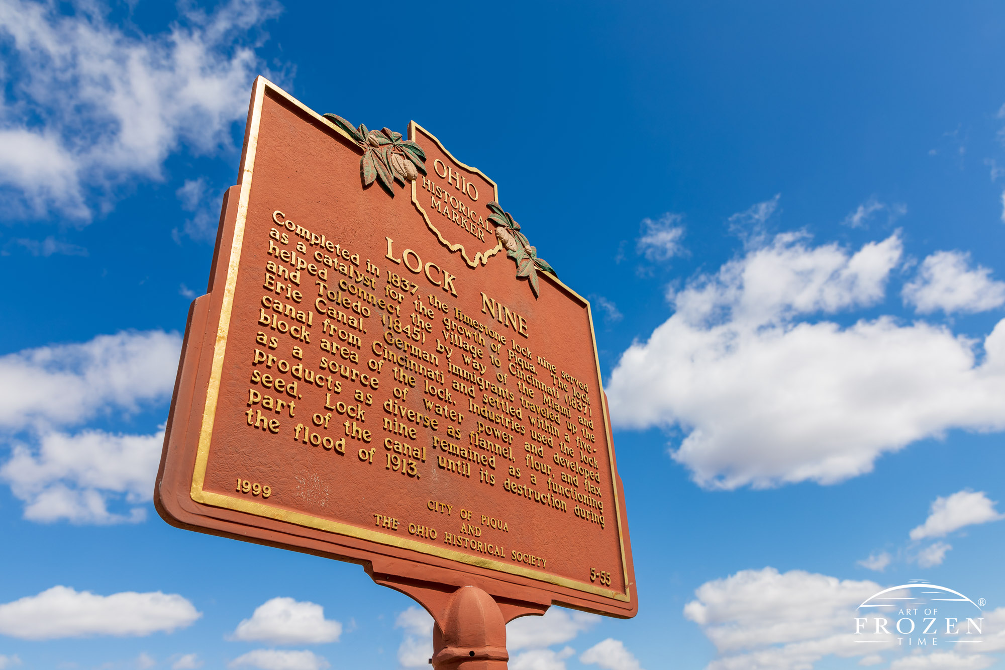 A close up view of the Lock Nine historical marker highlighting the feature's contribution to the Miami-Erie Canal.