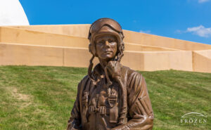 A bronze statue of Neil Armstrong dressed as a test pilot to include his flight helmet and oxygen mask