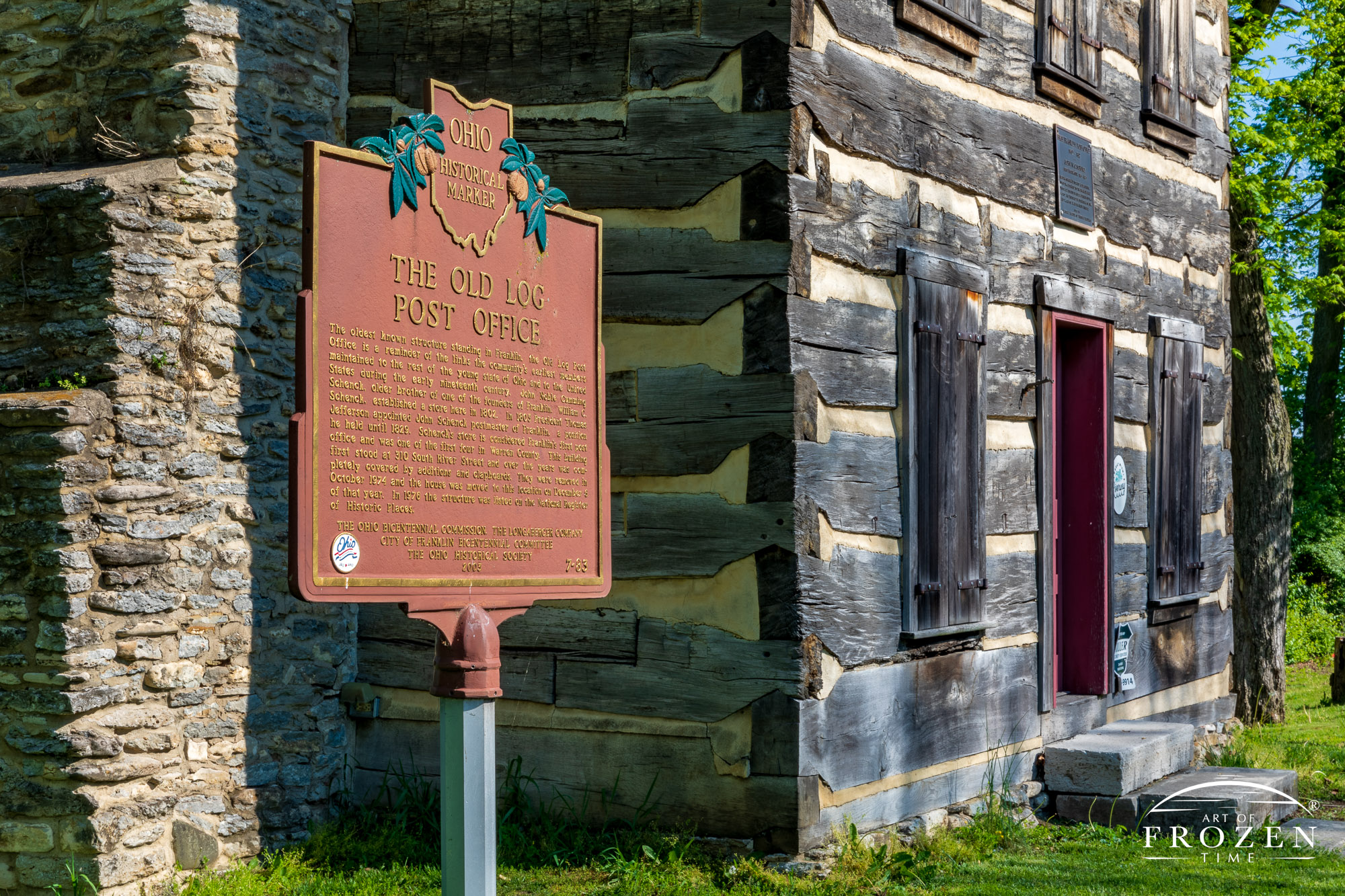 A historical sign sharing the history of the adjacent original log home which stands as Franklin Ohio’s oldest building and former post office