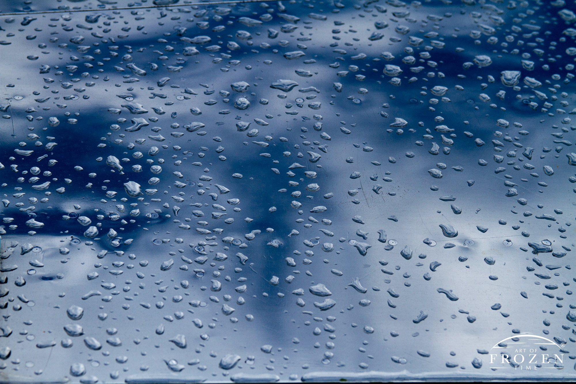 A close up view of a polished aluminum wing where raindrops shimmer on the reflective surface as the skies cleared.