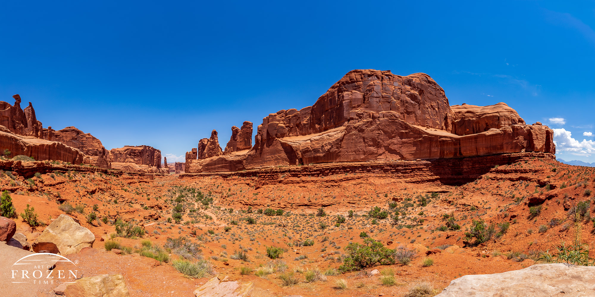 Two opposing walls of Entrada Sandstone several about a half mile long converging at a distance point as light raked down their vertical surfaces.