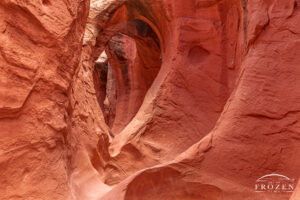 The iconic section of Peek-a-Boo Slot Canyon which shows a series of erosion cuts in the red Navajo Sandstone creating facinating textures and shapes