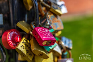 A close up view of Piqua Love Locks where padlocks with expressive messages are purposely abandoned on a pole-like structure.