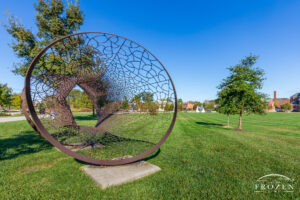 A steel hooped tunnel which mimics diagrams of space time displays chaotic surface designs which taken as a whole implies a sense of natural order