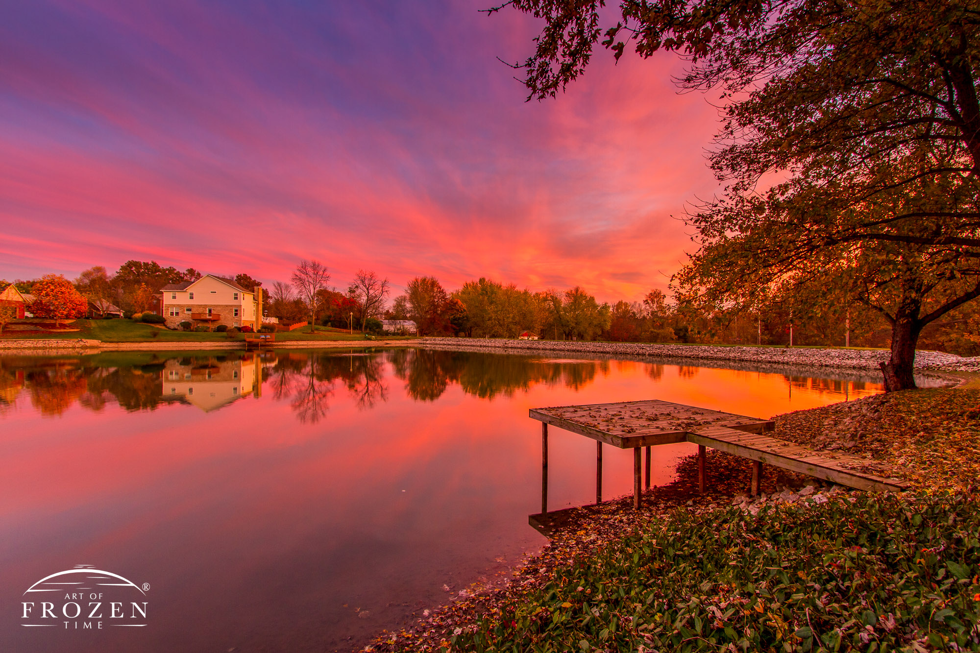 A local scene of a dock in a pond, where the orange sky attempted to match the autumn leaves.
