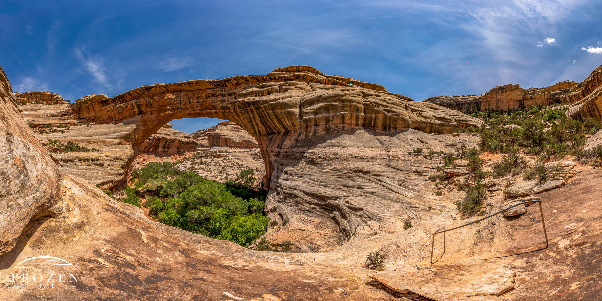 View of the Sipapu Natural Bridge from inside Natural Bridges National Monument where the stone arch spans the blue skies