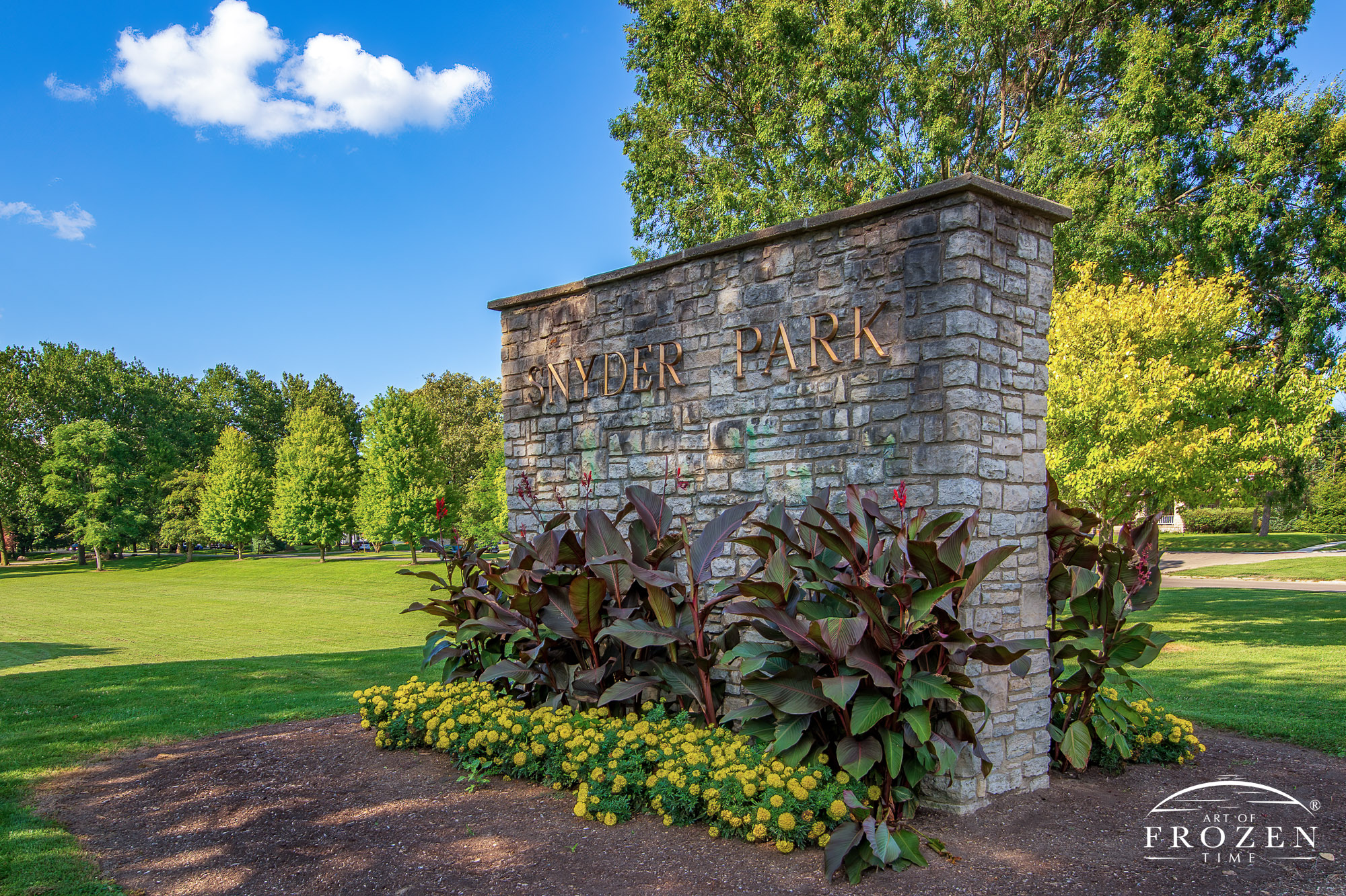 The Snyder Park stone sign surrounded by flower bed welcoming Springfield Ohio visitors to its features