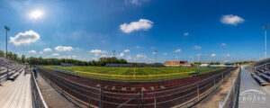 Wide-angle views of Springfield Wildcat Stadium on a sunny day featuring artificial turf and the school’s blue and yellow colors.