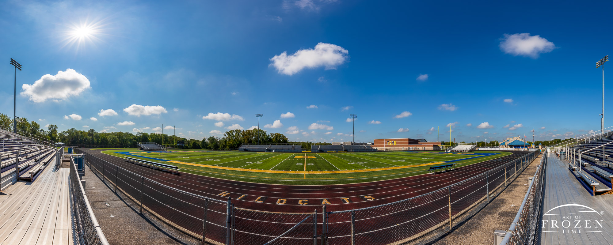 Wide-angle views of Springfield Wildcat Stadium on a sunny day featuring artificial turf and the school’s blue and yellow colors.
