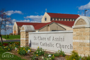 The entrance sign to St. Clare of Assisi in O'Fallon, Illinois on a pretty spring day