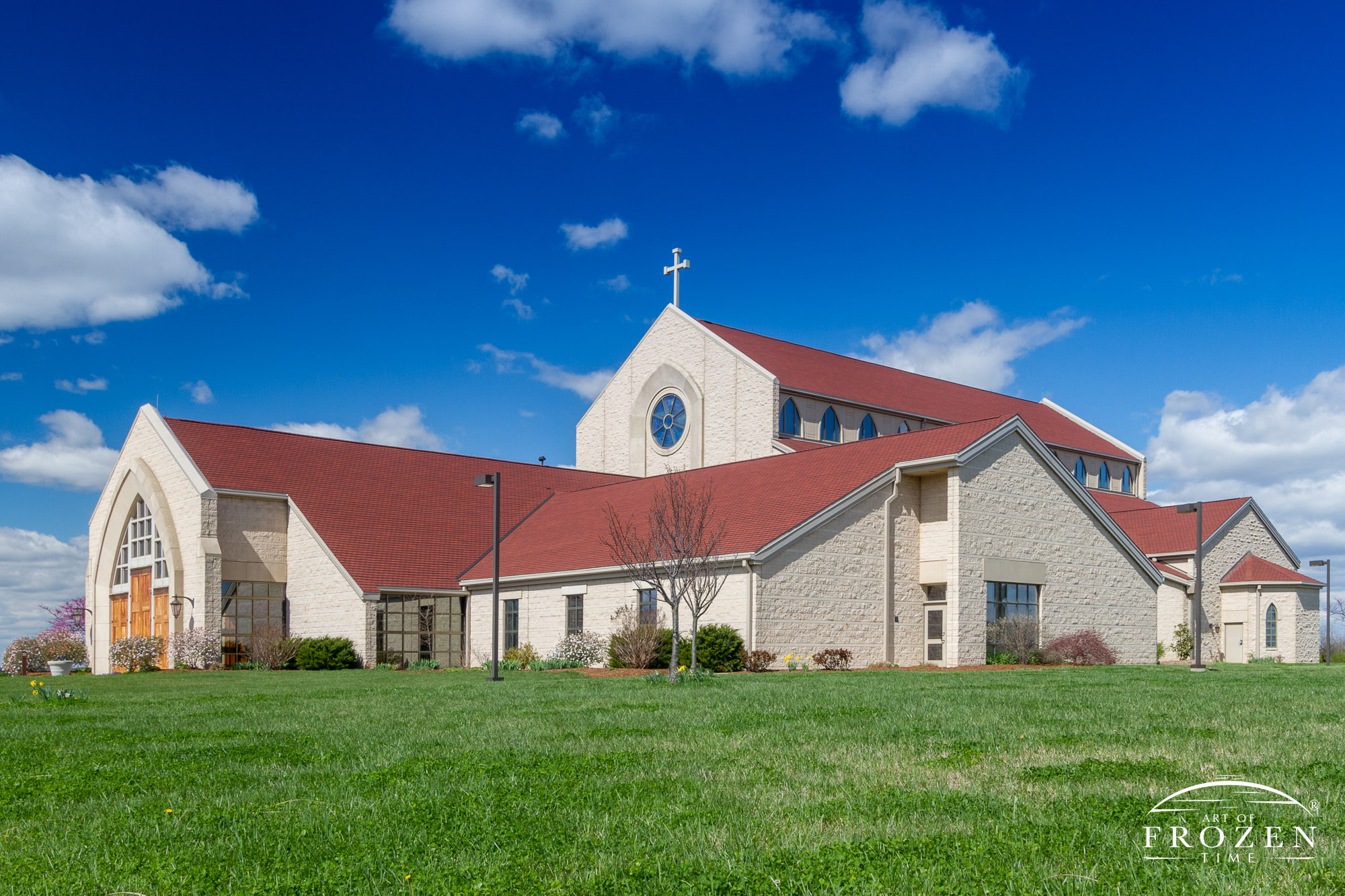 The outdoor view of St. Clare of Assisi, in O’Fallon Illinois on a blue sky in early Spring