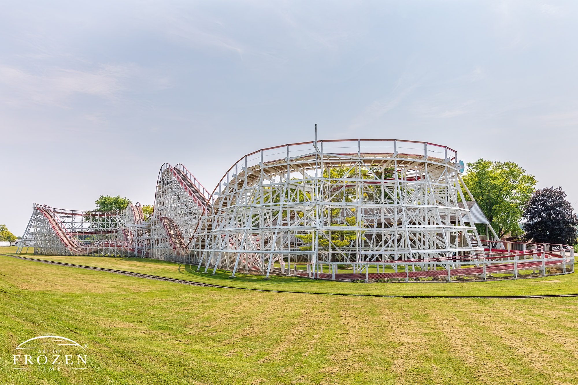 A classic wood rollercoaster entertains riders on a hot summer day during the Butler County Ohio Fair