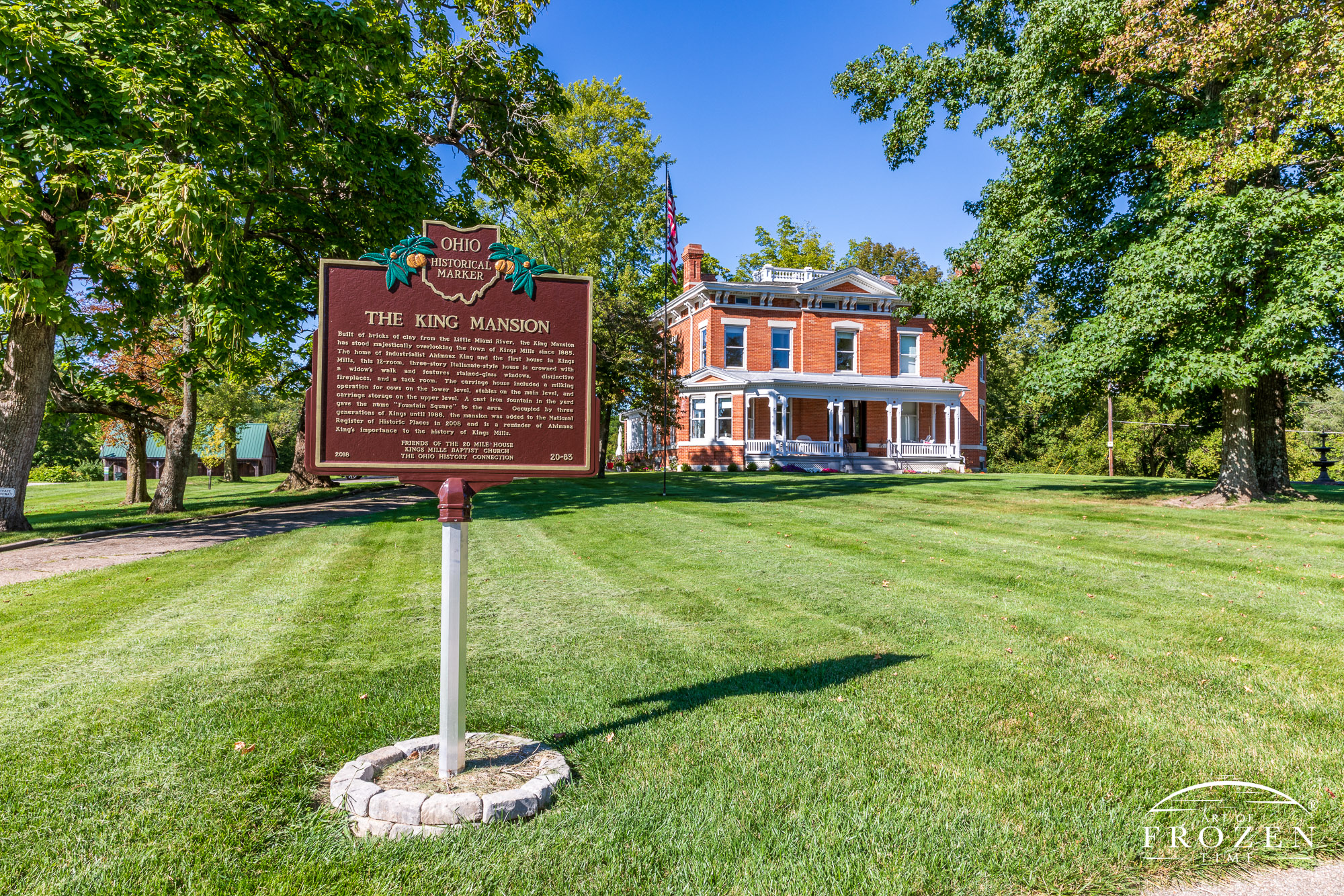 The King Mansion in Kings Mill Ohio is a red bricked Italianate structure white a white porch which on this day stands under Warren County’s blue azure skies.