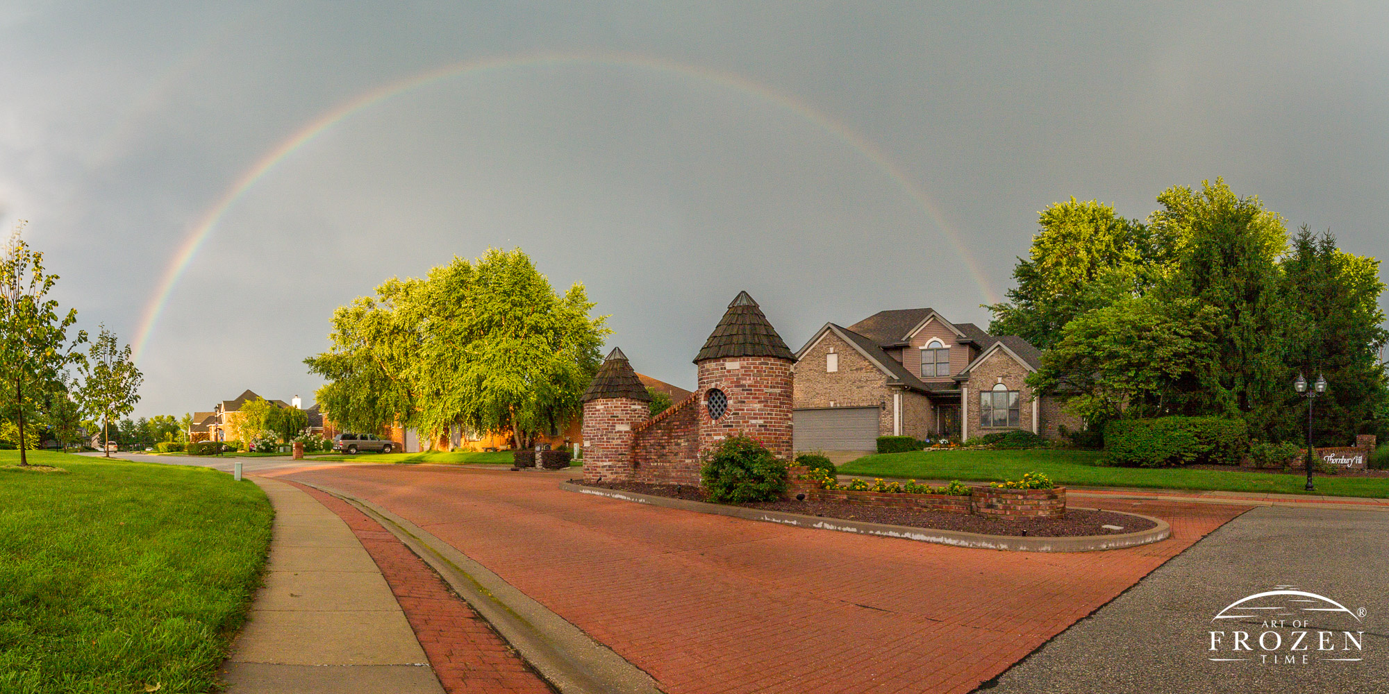 A full rainbow over Thornbury Hill subdivision entrance in O’Fallon Illinois during an afternoon rainshower