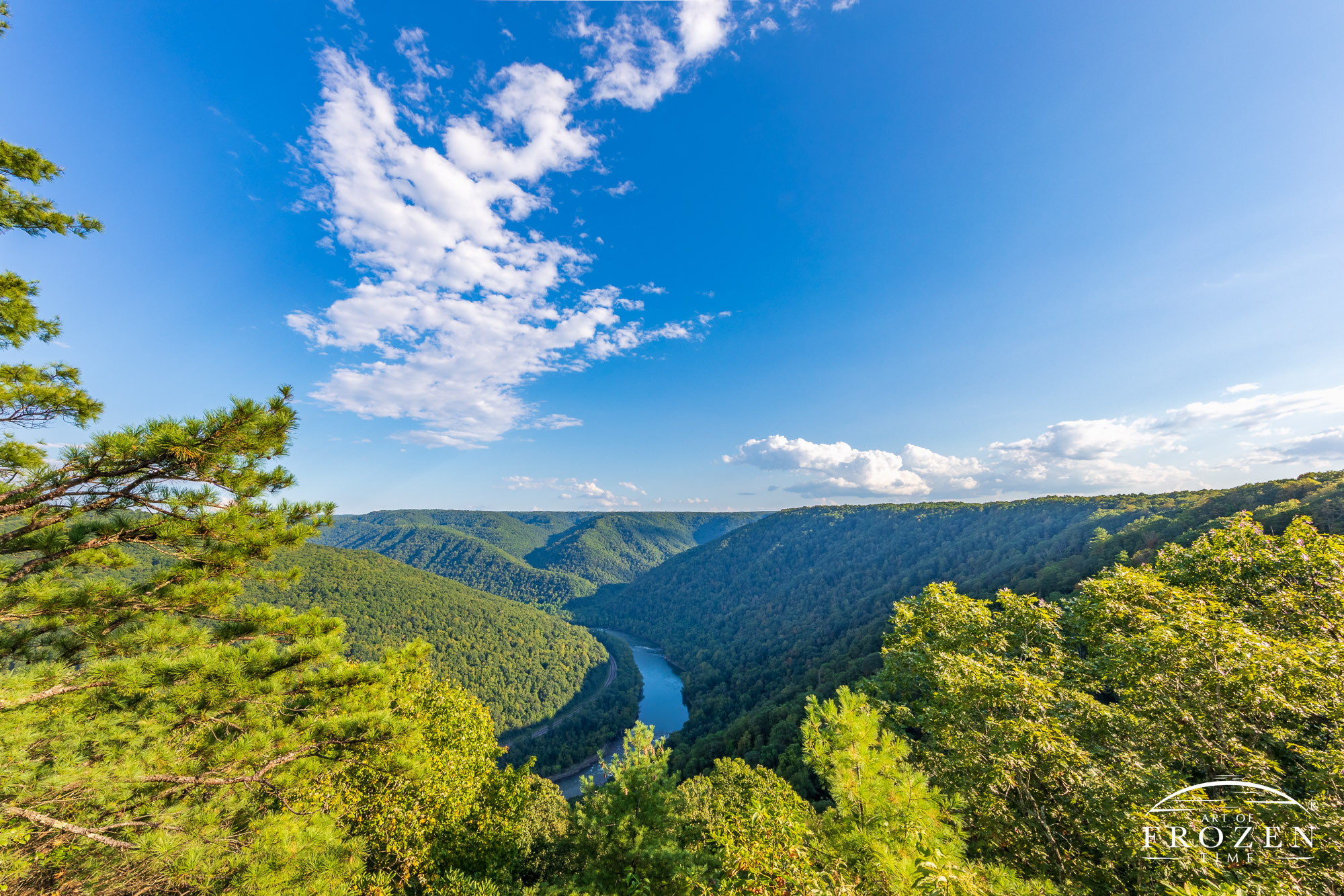 A panoramic view from the New River Gorge National River’s Turkey Spur Overlook which offers vast views to the New River Gorge and blue skies