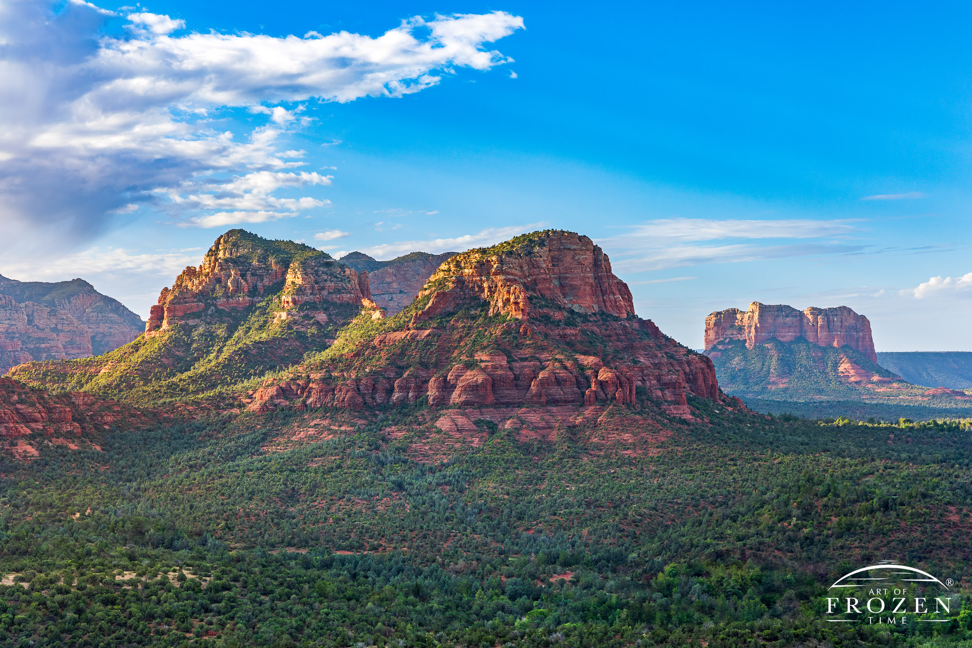 A morning view of Sedona, Arizona’s Twin Butte where golden light washed over the red rocks of the Schnebly Hill Formation