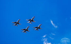 The US Air Force Aerial Demonstration Team Thunderbirds in diamond formation against a blue azure skies