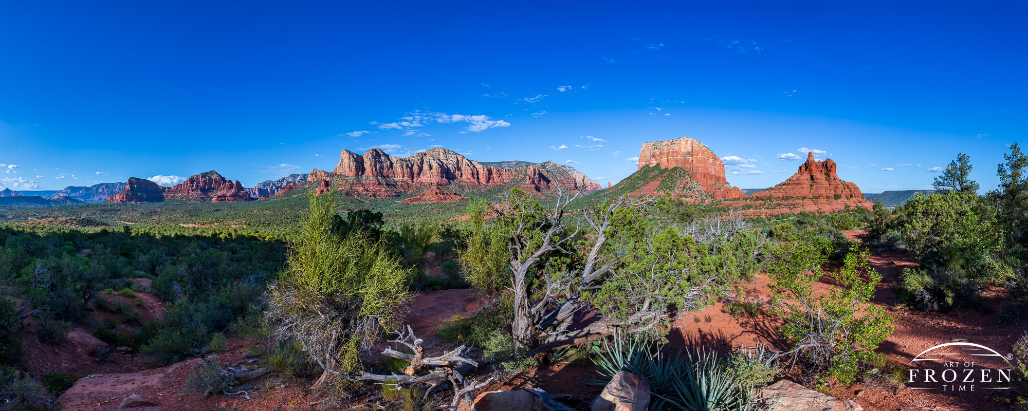 A panorama from Yavapai Vista Point, Sedona as evening light washes over Twin Butte, Munds Mountain, Courthouse Butte and Bell Rock